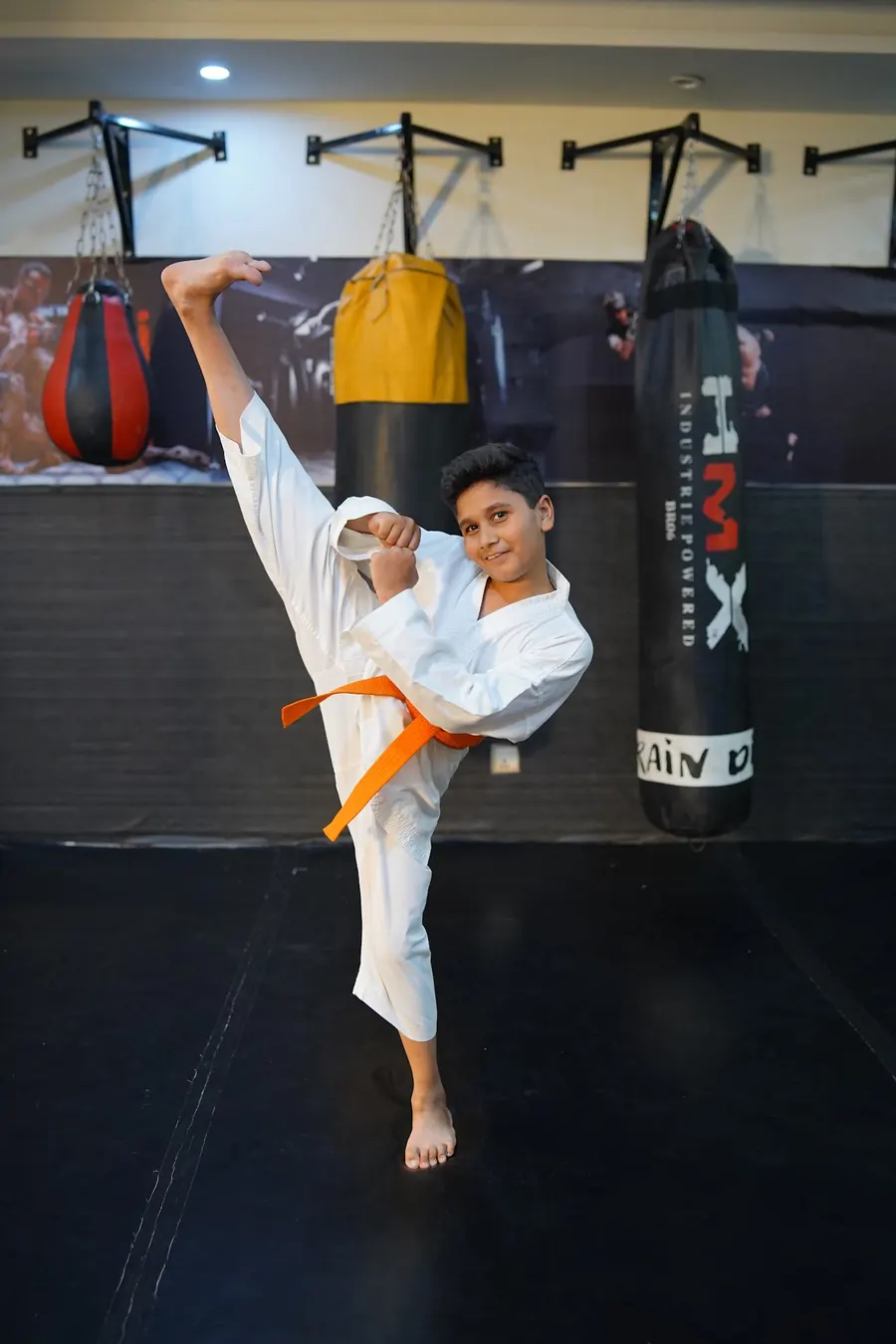 A young FightFit student throwing a high kick